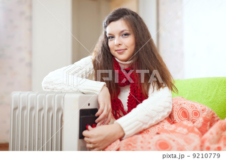 woman near oil heater 9210779