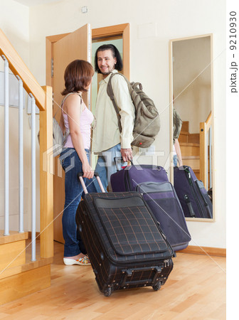 wonderful couple together with their luggage leaving home wonderful couple together with their luggage leaving home 9210930