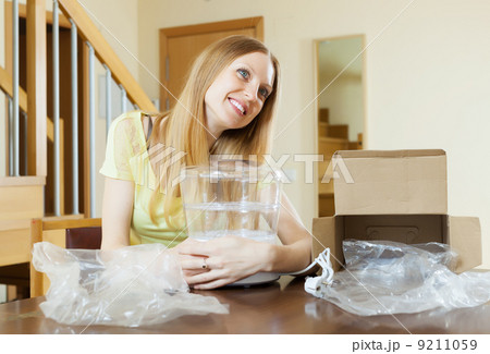 Happy woman with new electric steamer 9211059
