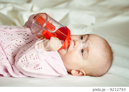 Baby girl with sippy cup Baby girl with sippy cup 9212793