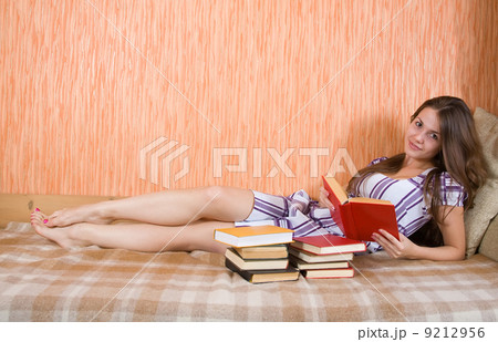 girl reading book on sofa girl reading book on sofa 9212956