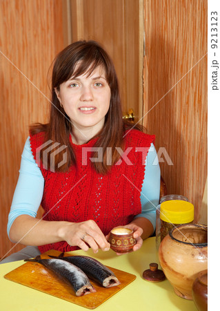 woman salting mackerel fish woman salting mackerel fish 9213123