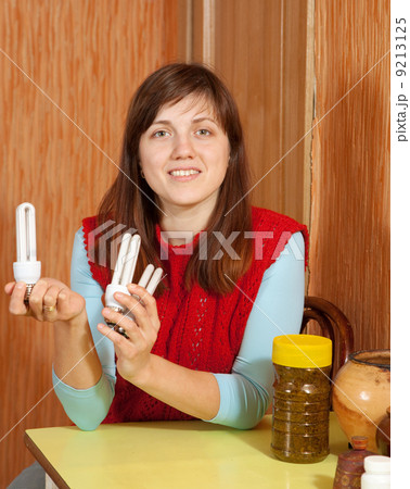 Girl holding energy saving bulbs Girl holding energy saving bulbs 9213125