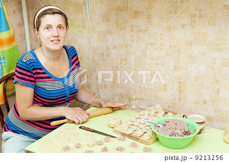 Woman making russian meat dumplings 9213256