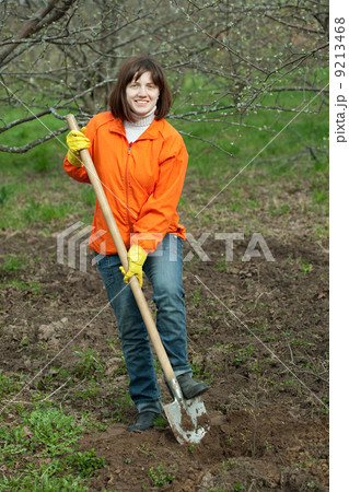 woman works with spade in garden 9213468