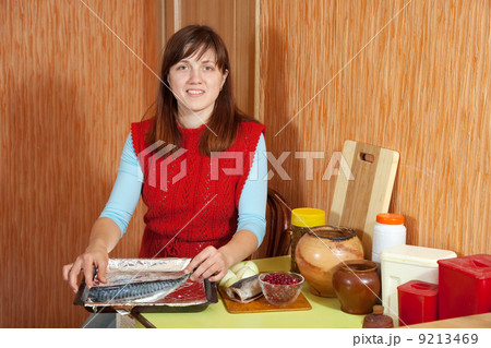 Woman foiling scomber fish Woman foiling scomber fish 9213469