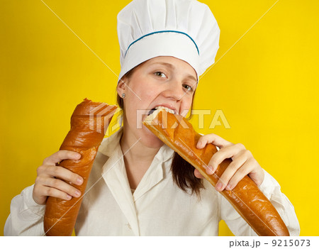 Woman is eating french bread 9215073