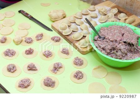 Rolling pin, dough and raw pelmeni Rolling pin, dough and raw pelmeni 9220987