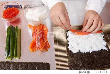 cook making sushi rolls with salmon cook making sushi rolls with salmon 9221084