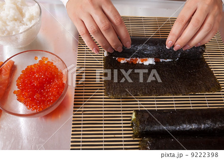 cook making Japanese sushi rolls 9222398