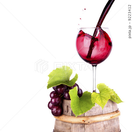 grapes and wine glass on a wooden vintage barrel 9223412