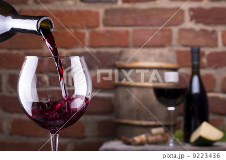 Glass of wine against a brick wall 9223436