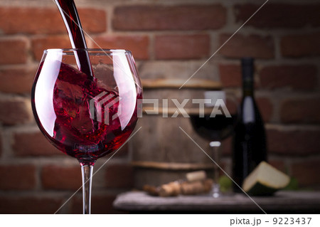 Glass of wine against a brick wall 9223437