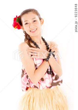 明るく爽やかな笑顔でフラダンスのポーズをする素敵な女性の写真素材