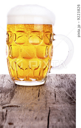 Beer glass on wooden table background Beer glass on wooden table background 9223826