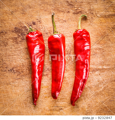 Red peppers on old wooden table Red peppers on old wooden table 9232847