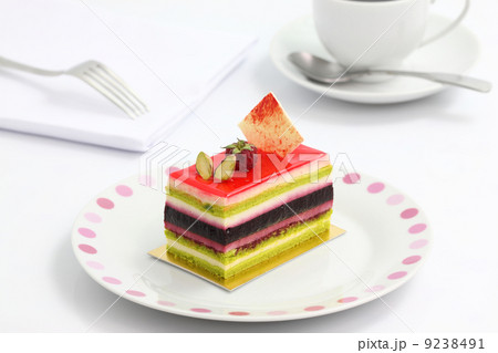 colorful fruit cake with coffee isolated in white background colorful fruit cake with coffee isolated in white background 9238491