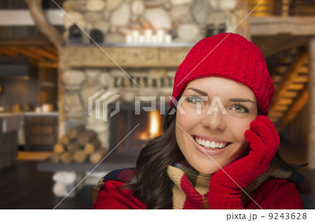 Mixed Race Girl Enjoying Warm Fireplace In Rustic Cabin 9243628