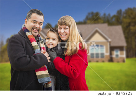 Happy Mixed Race Family in Front of House Happy Mixed Race Family in Front of House 9245325