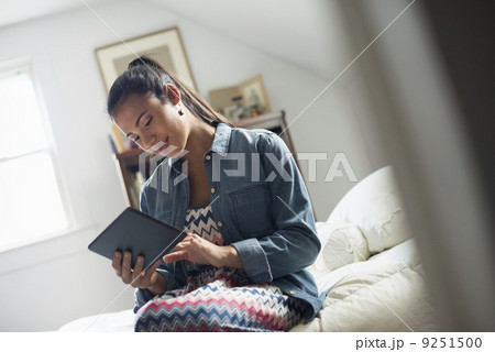 A young woman using a digital tablet. A young woman using a digital tablet. 9251500