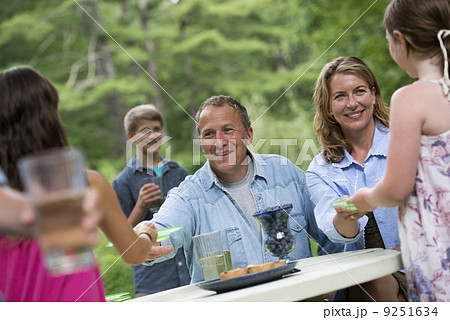 Organic Farm. An outdoor family party and picnic. Adults and children. 9251634