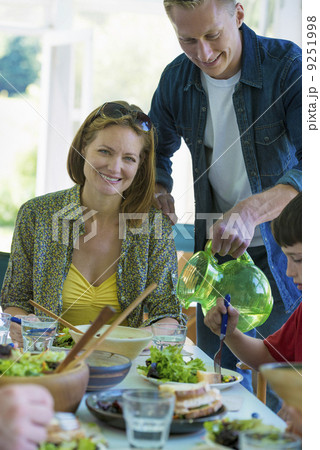 A family party around a table in a cafe. Adults and children. 9251998