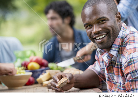 A summer party outdoors. A man smiling at the camera. A summer party outdoors. A man smiling at the camera. 9252227