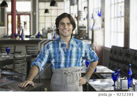 A cafe interior. A waiter in a checked shirt. A cafe interior. A waiter in a checked shirt. 9252393