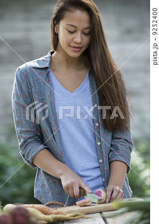A woman sorting and chopping freshly picked vegetables. 9252400