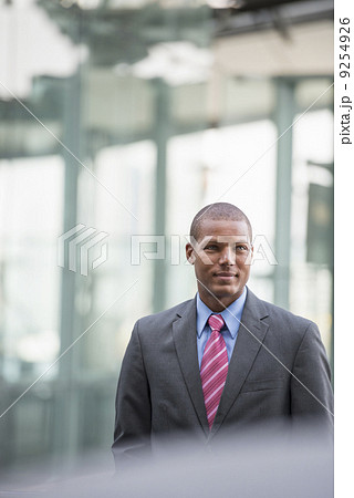 A Young Man In A Business Suit With A Blue Shirt And Red Tie. On A City Street. A Young Man In A Business Suit With A Blue Shirt And Red Tie. On A City Street. 9254926