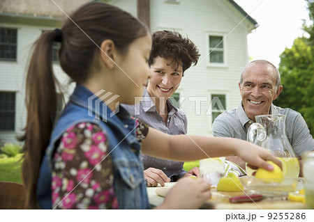 A Summer Family Gathering At A Farm. A Family Group, Parents And Children. Making Fresh Lemonade. 9255286