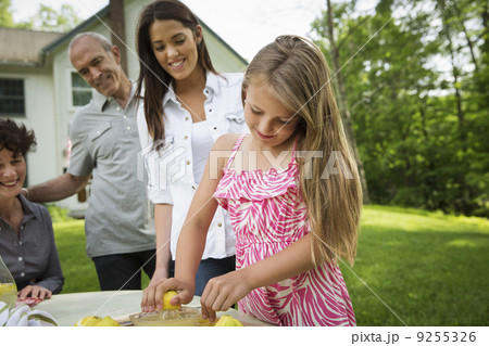 A Summer Family Gathering At A Farm. A Girl Slicing And Juicing Lemons To Make Lemonade. A Summer Family Gathering At A Farm. A Girl Slicing And Juicing Lemons To Make Lemonade. 9255326