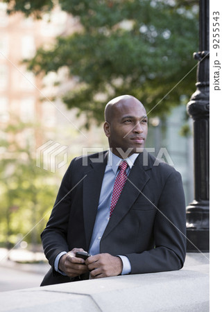 Business People. A Man In A Suit Leaning On A Balustrade Under A Lamppost. Waiting.  9255543