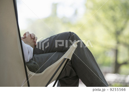 City Life. A Man Sitting In A Canvas Camping Chair In The Park. City Life. A Man Sitting In A Canvas Camping Chair In The Park. 9255566