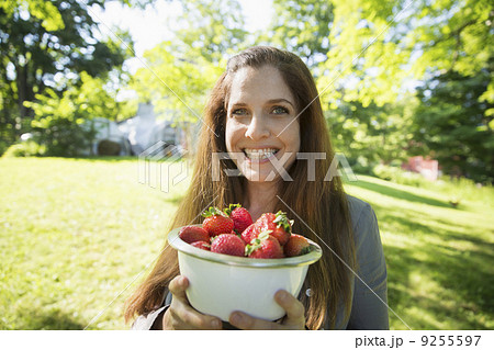 On The Farm. A Woman Carrying A Bowl Of Organic Fresh Picked Strawberries. On The Farm. A Woman Carrying A Bowl Of Organic Fresh Picked Strawberries. 9255597