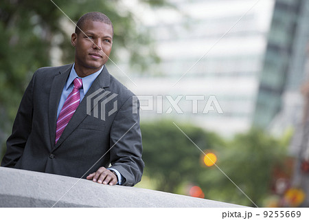 A Young Man In A Business Suit With A Blue Shirt And Red Tie. On A City Street.  9255669