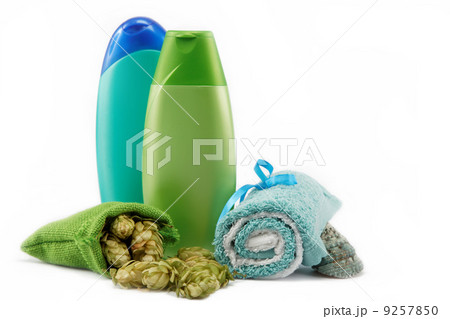 Spa or bathroom concept with towels, soaps and hops on a white b 9257850