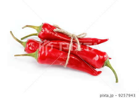 Red hot chili peppers tied with rope isolated on white 9257943