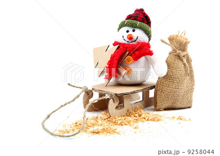 Snowman on a sled with a Christmas tree and sackcloth. Snowman on a sled with a Christmas tree and sackcloth. 9258044