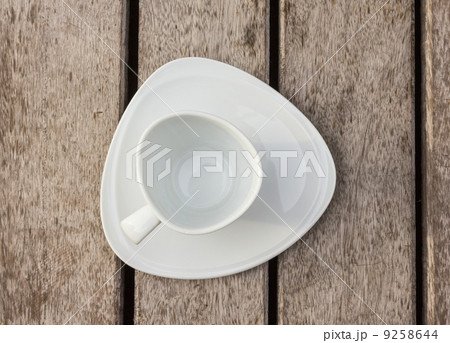 Empty coffee cup on wood floor 9258644