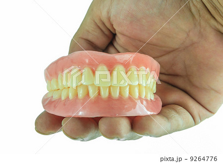 Full denture in hand 9264776