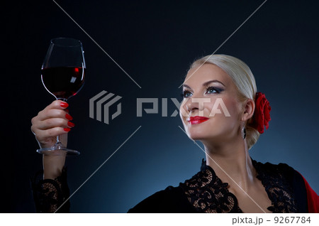Beautiful flamenco dancer holding a glass of wine 9267784