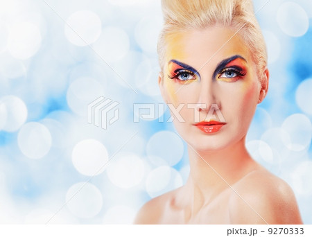 Beautiful woman in purple dress over abstact blurred background Beautiful woman in purple dress over abstact blurred background 9270333