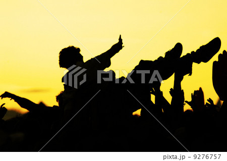 crowdsurfer open-air crowd cheering sunset 9276757