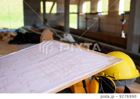hard hat working place at building site with plan 9276990