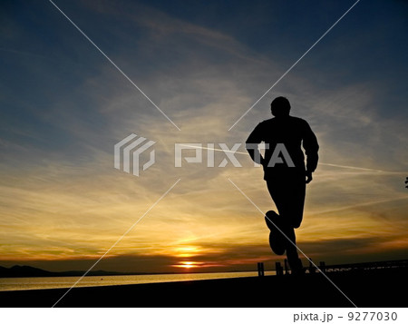 silhouette of a jogger in sunrise 9277030