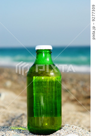 fresh closed beer bottle at beach 9277309