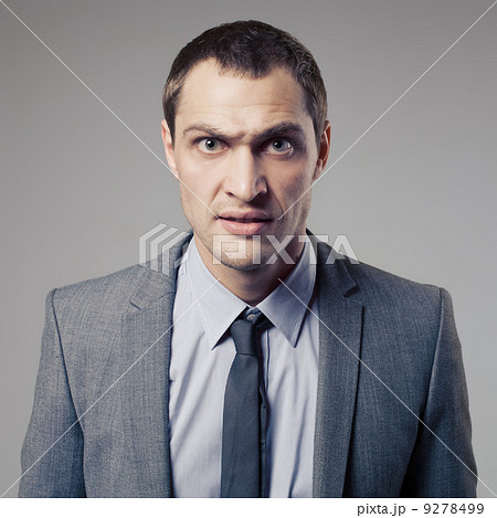 Angry Businessman On Gray Background Angry Businessman On Gray Background 9278499