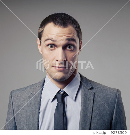 Confused Businessman On Gray Background 9278509