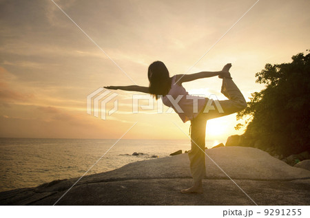 yoga girl performing yoga pose on a beach 9291255